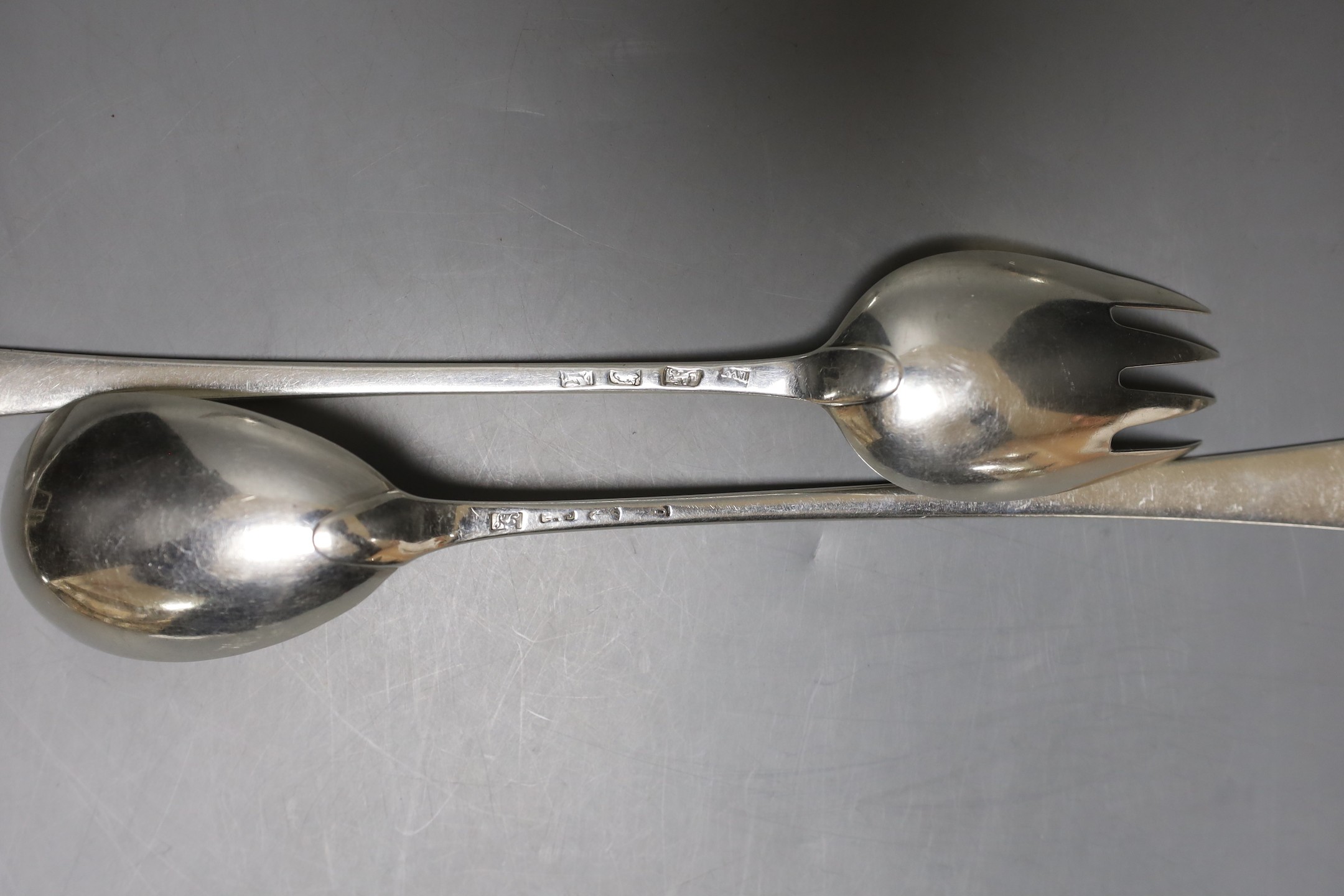 Two George III silver Old English pattern feather edge basting spoons and a pair of similar servers, various makers and dates, marks rubbed, approx. 28.5cm, 11.5oz.